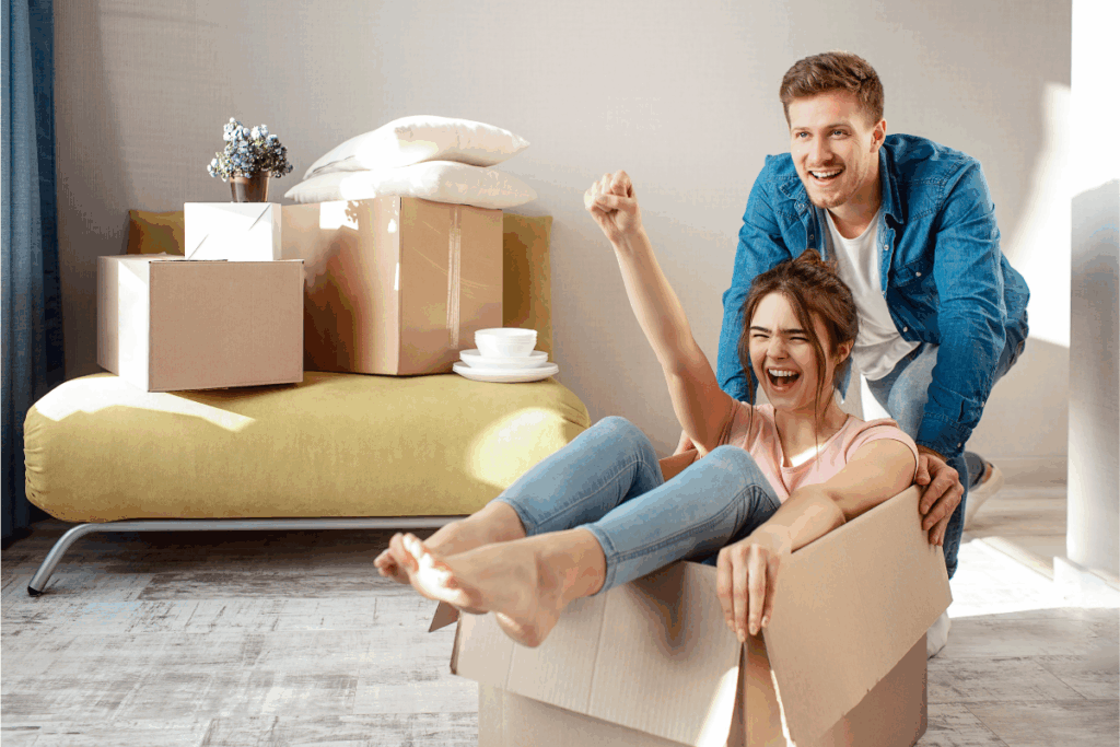 Happy couple sold their home and having fun moving