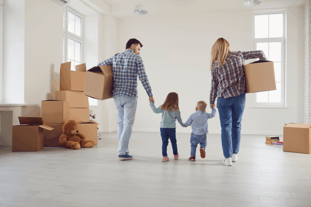Family packing up a living room with sentimental items during a move
