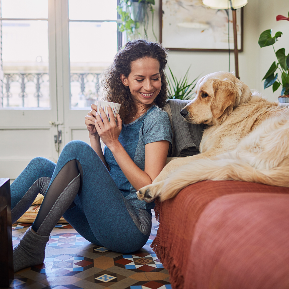 selling your home during divorce happy woman and her dog