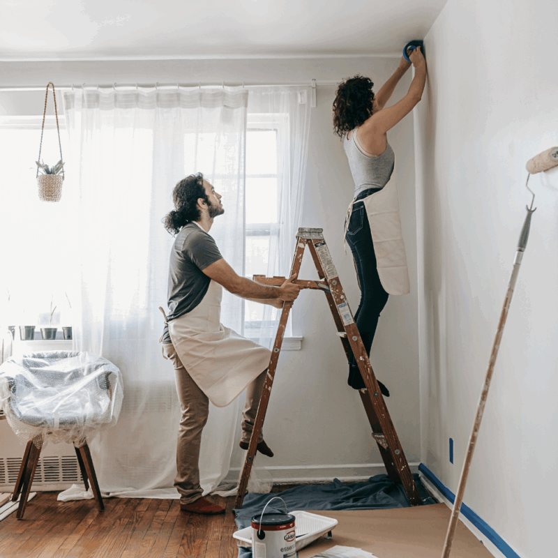 couple remodeling their home, couple working hard repainting selling off-market