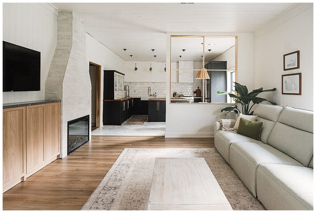 Modern living room with book shelves, organic textures, white oak, granite, mid-century